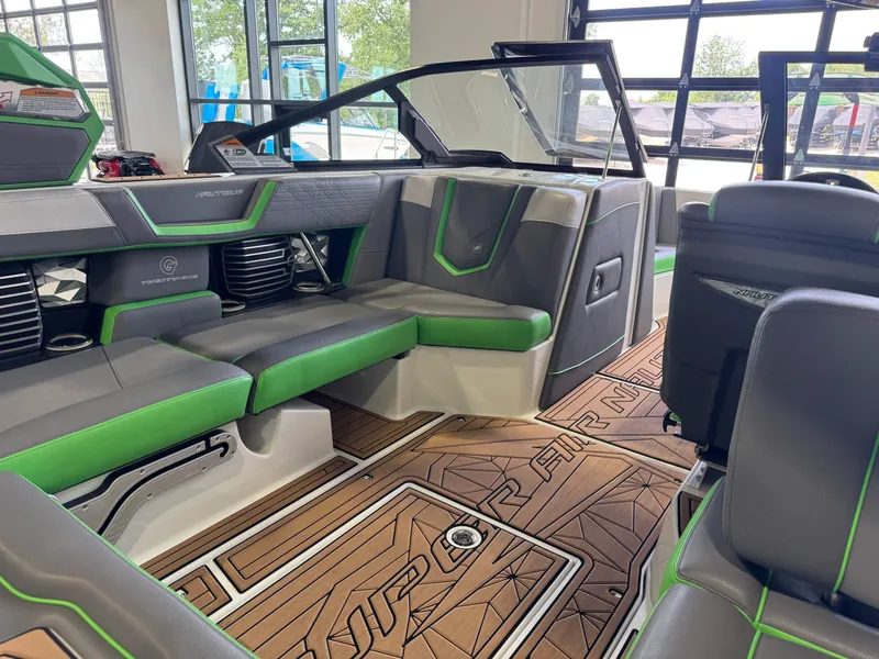 Slide: The Image of Interior of a 2019 Nautique Super Air Nautique G21 with green accents. - 14
