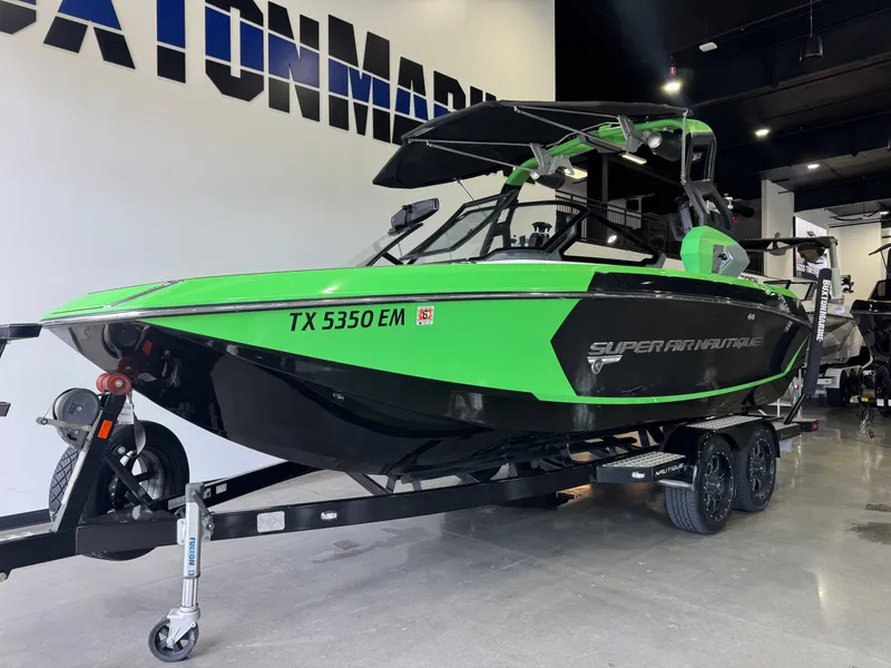 Slide: The Image of 2019 Nautique Super Air Nautique G21 boat in vibrant green on display. - 2