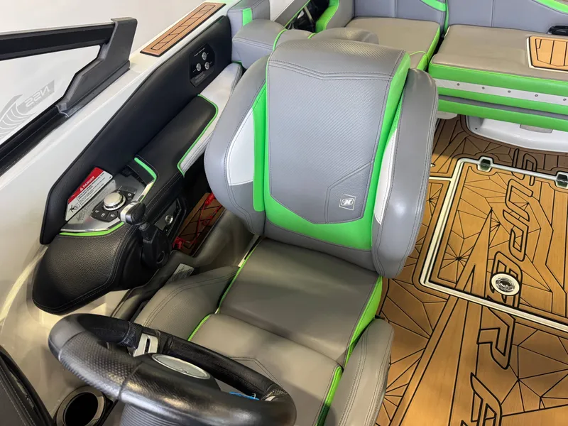 Slide: The Image of Interior of 2019 Nautique Super Air Nautique G21 with green and gray seats. - 21