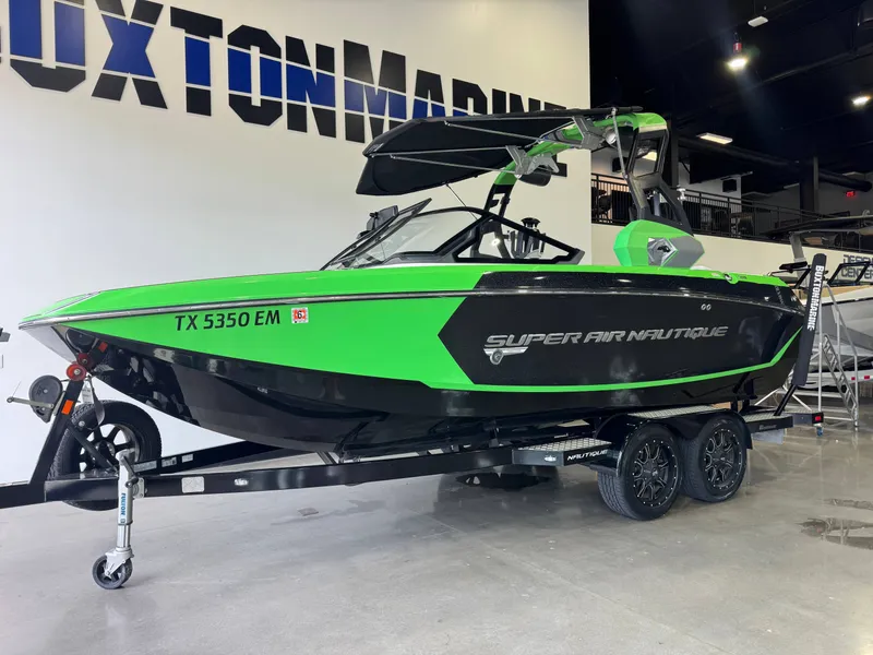 Slide: The Image of 2019 Nautique Super Air Nautique G21 boat in vibrant green on trailer. - 3