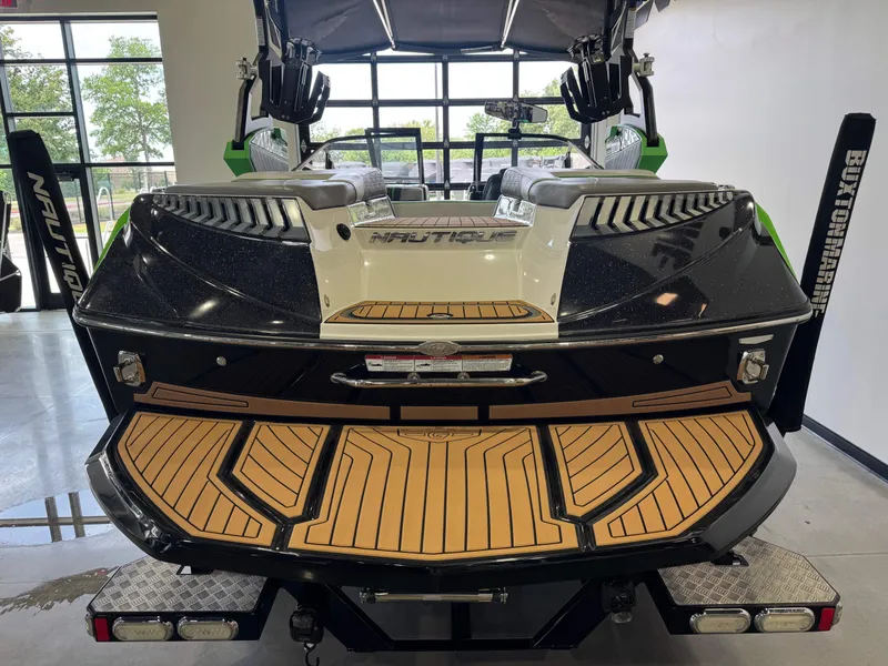 Slide: The Image of Rear view of a 2019 Nautique Super Air Nautique G21 boat in showroom. - 8