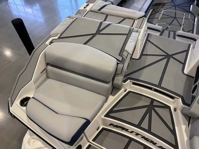 Slide: The Image of 2024 Nautique Super Air G25 Paragon boat interior with gray upholstery. - 12