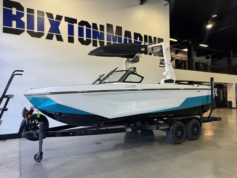 Slide: The Image of 2026 Nautique Super Air Nautique GS22 on a trailer in a showroom. - 3
