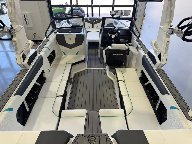 Slide: The Image of Interior view of a modern boat with white and gray seating, steering wheel, and ample space. - 13