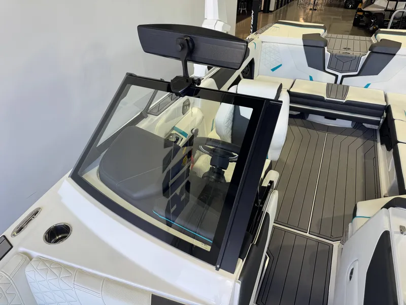 Slide: The Image of The image shows the cockpit of a modern boat with white seats and gray flooring. - 20