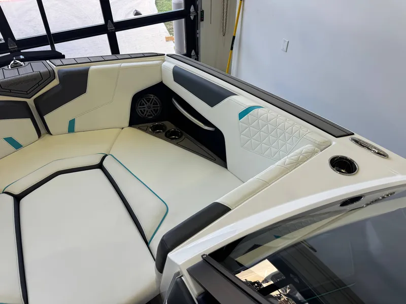 Slide: The Image of Interior of a modern boat with stylish white and black seating and blue accents. - 18