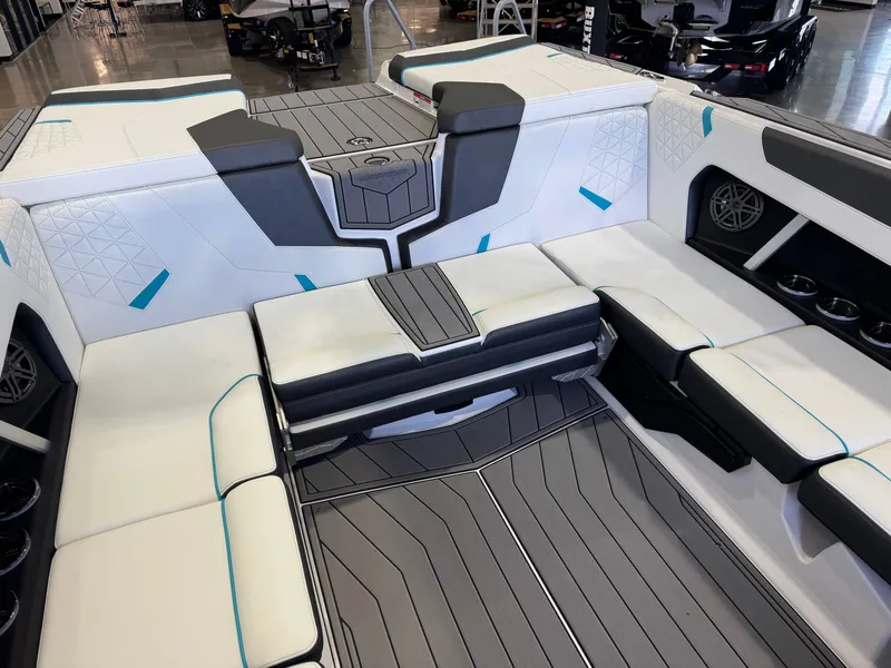 Slide: The Image of Interior of a modern boat with white and gray seating and blue accents. - 16