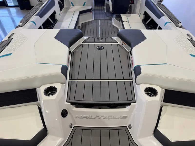 Slide: The Image of Interior view of a modern boat with white and gray seating and flooring. - 10