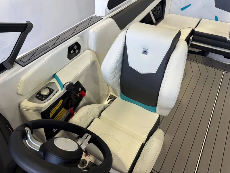 Slide: The Image of The image shows the interior of a modern boat with a white and gray seat and steering wheel. - 21