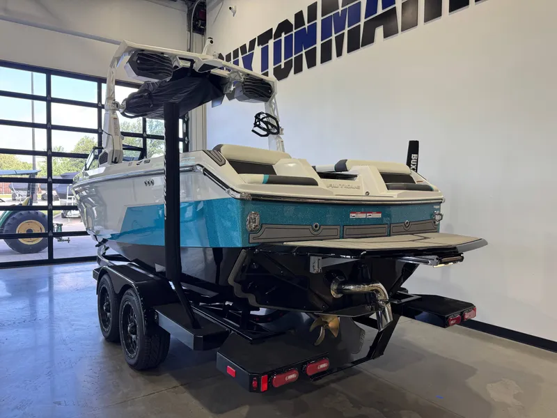 Slide: The Image of The image shows a blue and white boat on a trailer in a showroom. - 5