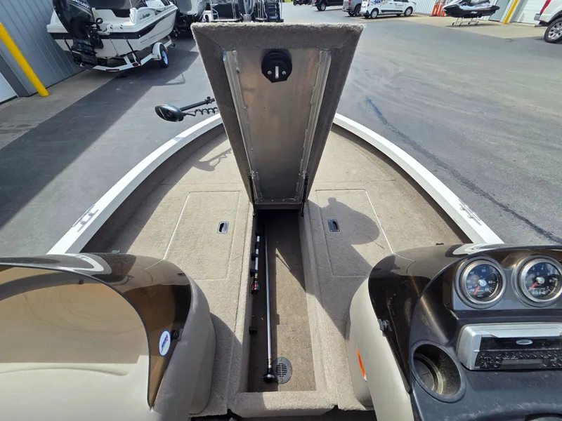 Slide: The Image of Interior view of a 2004 Crestliner CMV 1750 boat with open storage compartment. - 16