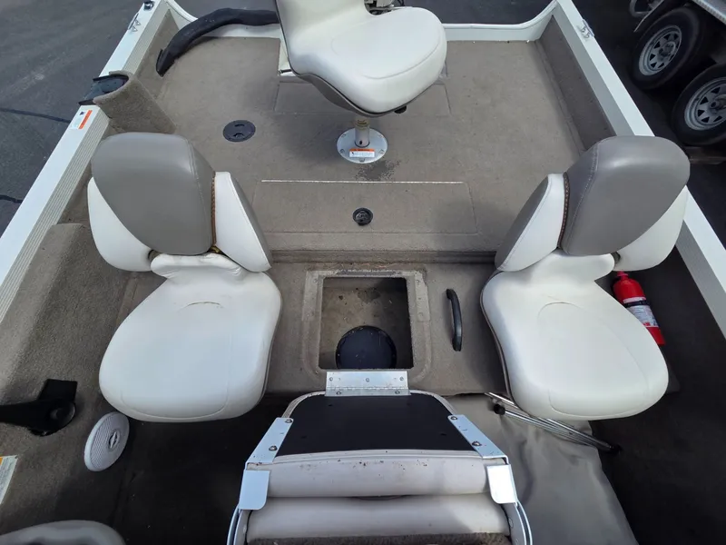 Slide: The Image of Interior of a 2004 Crestliner CMV 1750 boat with three seats. - 21