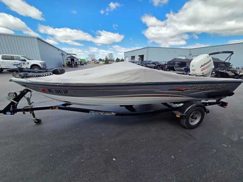 Slide: The Image of 2004 Crestliner CMV 1750 boat with cover on trailer. - 8
