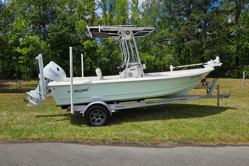 The Image of 2022 Bulls Bay 2000 boat on trailer, parked on grass with trees in background. - 0