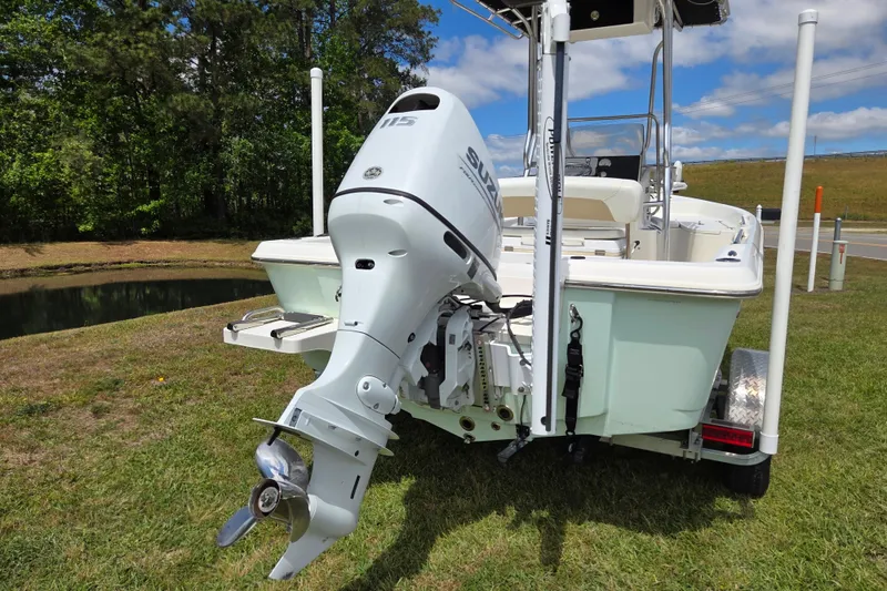 Slide: The Image of Bulls Bay 2000 boat with Suzuki outboard motor, parked on grass, 2022 model. - 3