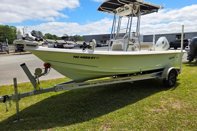 Slide: The Image of 2022 Bulls Bay 2000 boat on trailer, parked on grass under a partly cloudy sky. - 7