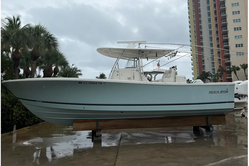 The Image of 2018 Regulator 31 boat on display, surrounded by palm trees and buildings. - 1