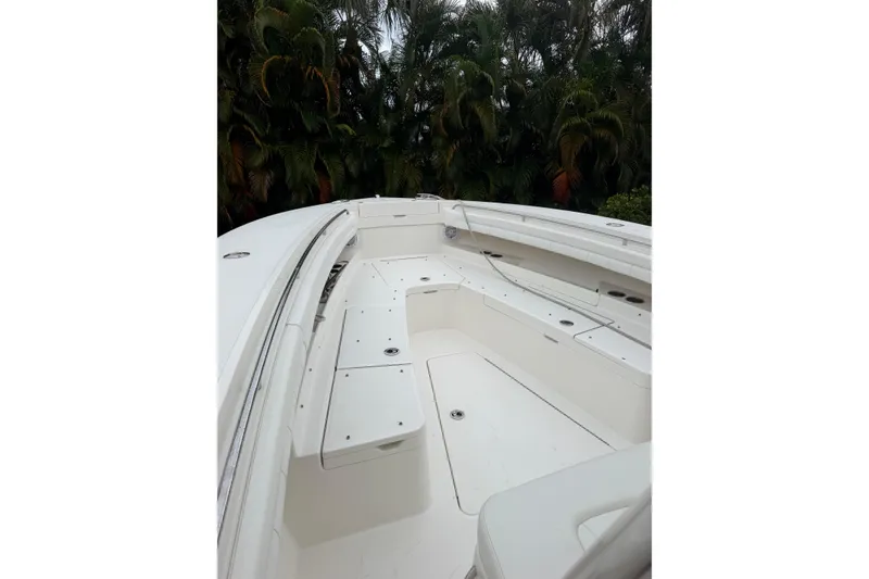 Slide: The Image of 2018 Regulator 31 boat interior with white seating and storage compartments. - 16