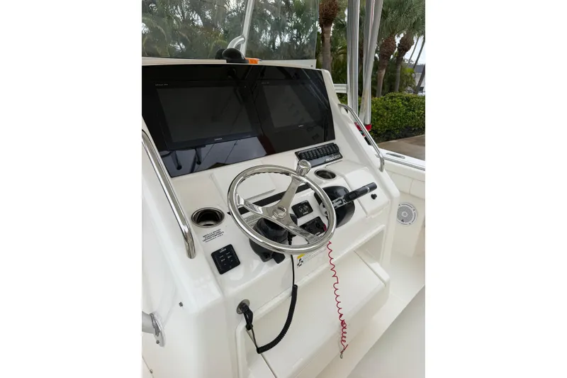 Slide: The Image of 2018 Regulator 31 boat helm with steering wheel and electronic displays. - 18