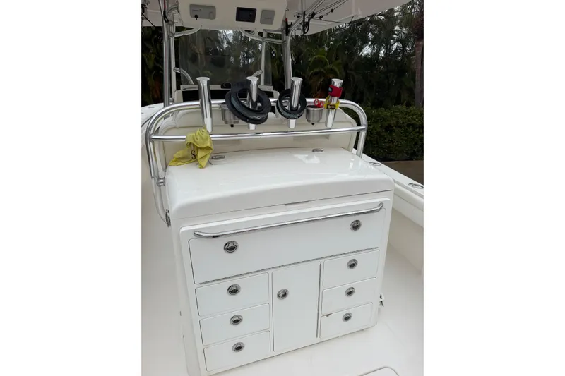 Slide: The Image of 2018 Regulator 31 boat console with storage drawers and fishing rod holders. - 20