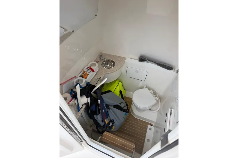 Slide: The Image of 2018 Regulator 31 boat interior with toilet, sink, and storage items. - 26
