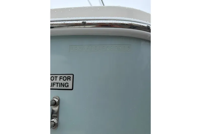 Slide: The Image of 2018 Regulator 31 boat hull with identification number and lifting warning label. - 28