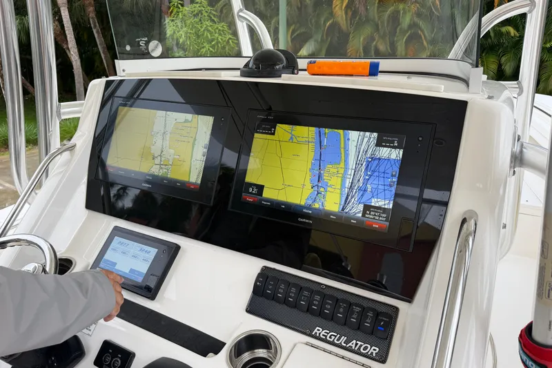 Slide: The Image of Control panel of a 2018 Regulator 31 boat with navigation screens and controls. - 6