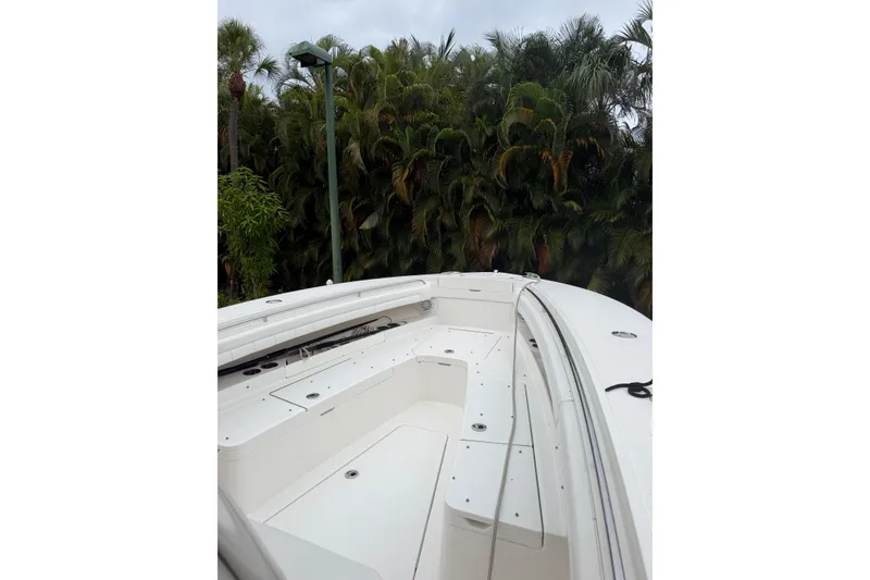 Slide: The Image of 2018 Regulator 31 boat deck with lush greenery background. - 8