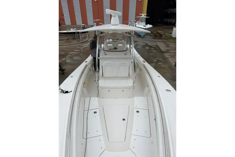 Slide: The Image of 2018 Regulator 31 boat with spacious deck and modern design in a marina setting. - 9