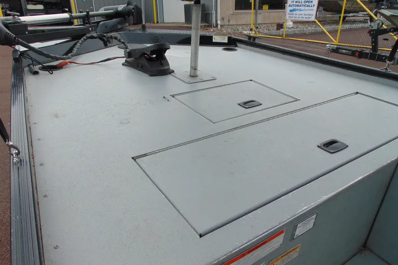 Slide: The Image of 2016 Crestliner 1600 Storm Poly boat deck with storage compartments and trolling motor. - 10