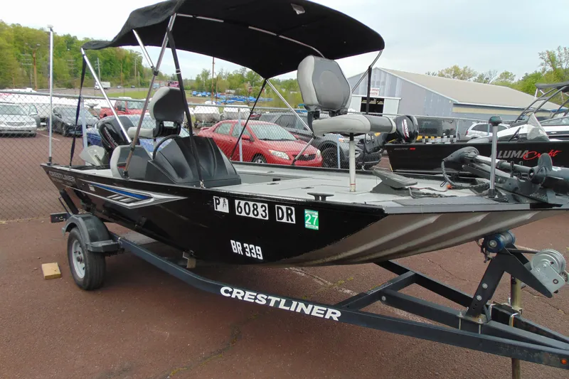 Slide: The Image of 2016 Crestliner 1600 Storm Poly fishing boat on trailer, parked outdoors. - 3