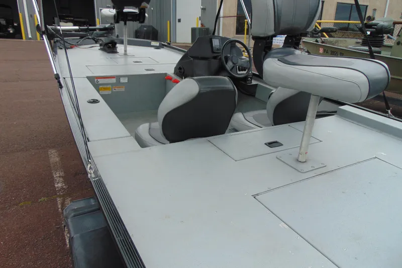 Slide: The Image of 2016 Crestliner 1600 Storm Poly boat interior with seating and steering console. - 7