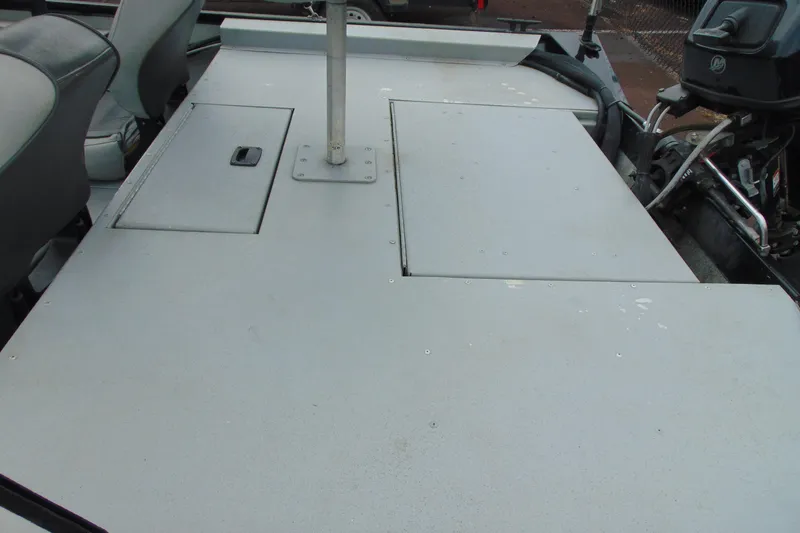 Slide: The Image of 2016 Crestliner 1600 Storm Poly boat deck with storage compartments and seating. - 8