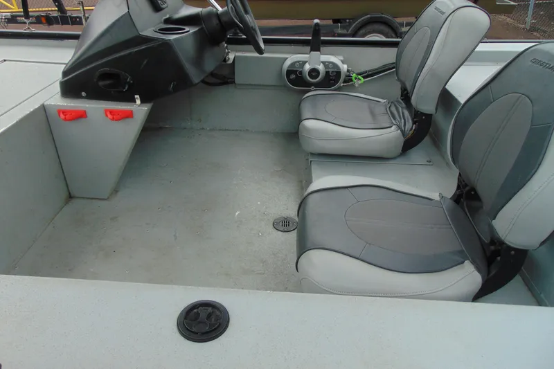 Slide: The Image of 2016 Crestliner 1600 Storm Poly boat interior with dual seats and steering console. - 9