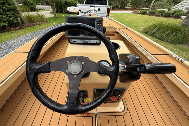 Slide: The Image of Steering wheel and controls of a 2018 Cast and Blast 17CC boat. - 11