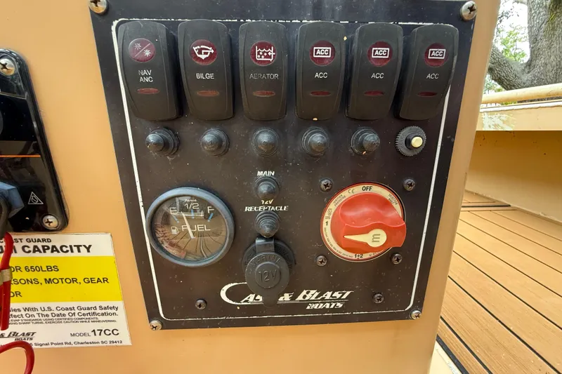 Slide: The Image of Control panel of a 2018 Cast and Blast 17CC boat with switches and fuel gauge. - 13
