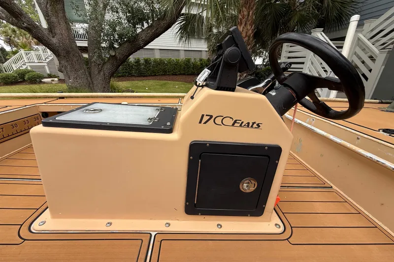 Slide: The Image of 2018 Cast and Blast 17CC boat console with steering wheel and storage compartment. - 15