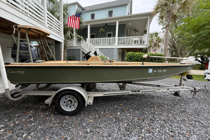 Slide: The Image of 2018 Cast and Blast 17CC boat on trailer, parked in front of a house with American flag. - 3
