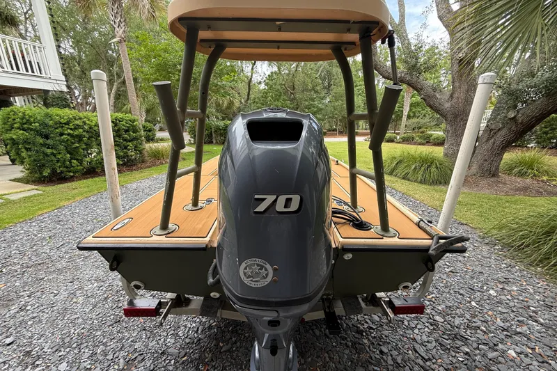 Slide: The Image of 2018 Cast and Blast 17CC boat with 70 horsepower engine, parked on gravel driveway. - 6