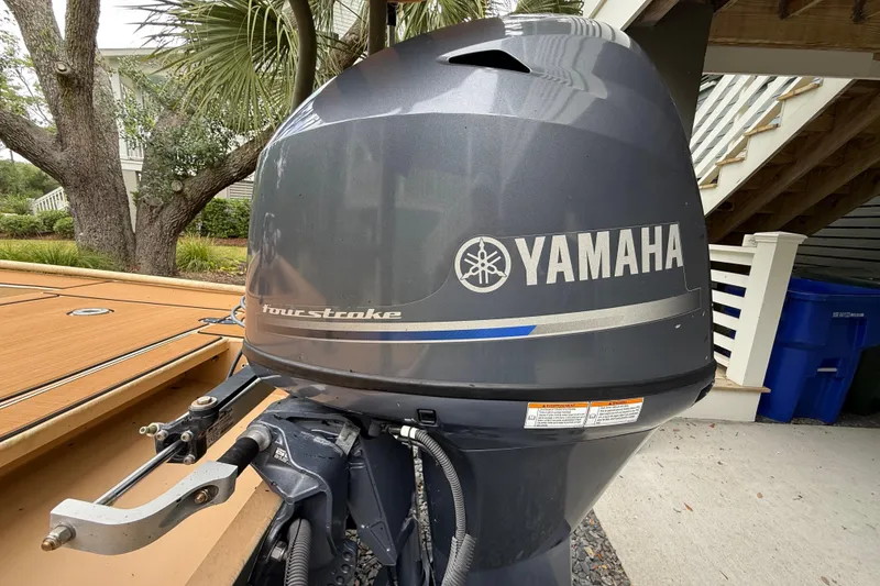 Slide: The Image of Yamaha four-stroke outboard motor on 2018 Cast and Blast 17CC boat, parked outdoors. - 8
