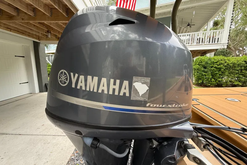 Slide: The Image of Yamaha four-stroke outboard motor on 2018 Cast and Blast 17CC boat, parked under a porch. - 9