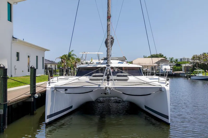 Slide: The Image of 2020 Fountaine Pajot Saona 47 catamaran docked in a sunny marina setting. - 11