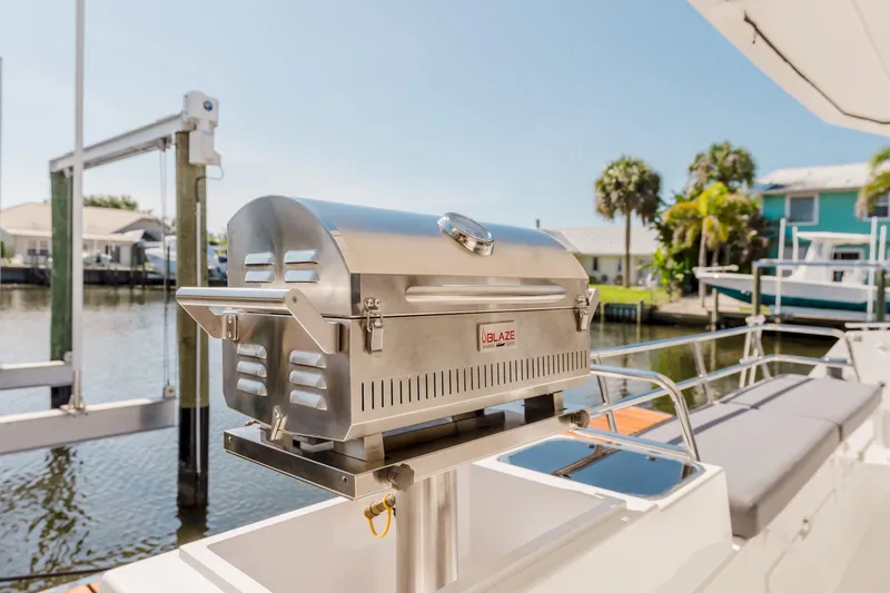 Slide: The Image of Stainless steel grill on 2020 Fountaine Pajot Saona 47 yacht, docked by waterfront homes. - 18