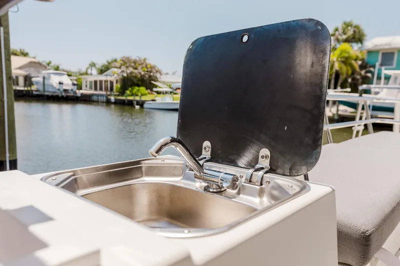 Slide: The Image of Outdoor sink on 2020 Fountaine Pajot Saona 47 catamaran, docked by waterfront homes. - 19
