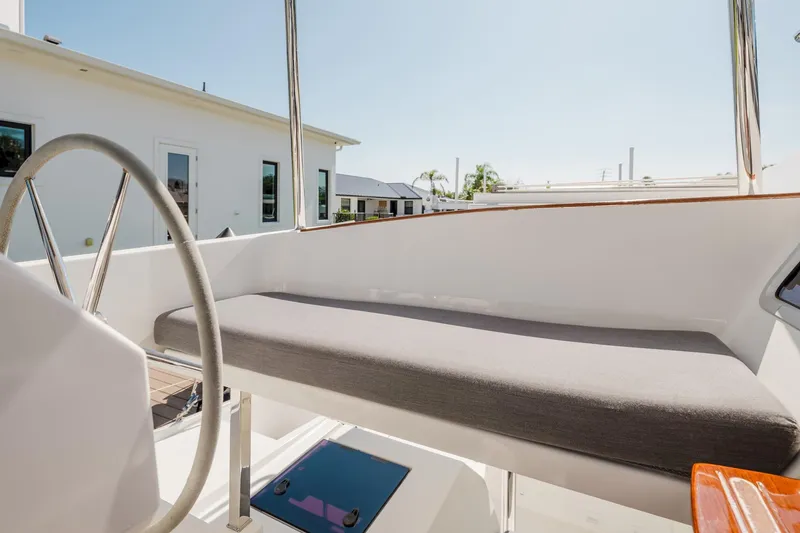 Slide: The Image of Helm station of 2020 Fountaine Pajot Saona 47 catamaran with cushioned seating. - 23