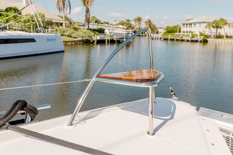 Slide: The Image of Fountaine Pajot Saona 47 catamaran, 2020 model, docked in a serene marina setting. - 24