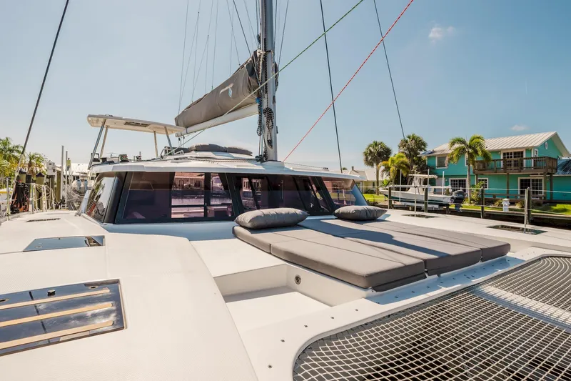 Slide: The Image of 2020 Fountaine Pajot Saona 47 catamaran with spacious deck and modern design in marina setting. - 26
