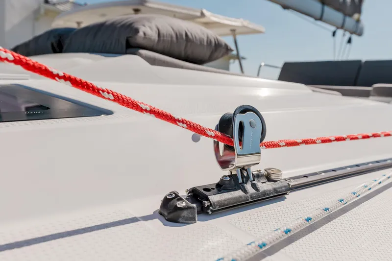 Slide: The Image of Close-up of a 2020 Fountaine Pajot Saona 47 sailboat deck with red rope and pulley system. - 32