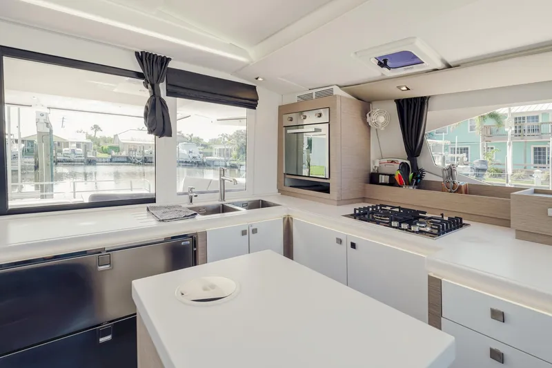 Slide: The Image of Modern kitchen interior of 2020 Fountaine Pajot Saona 47 catamaran with sleek appliances and waterfront view. - 36