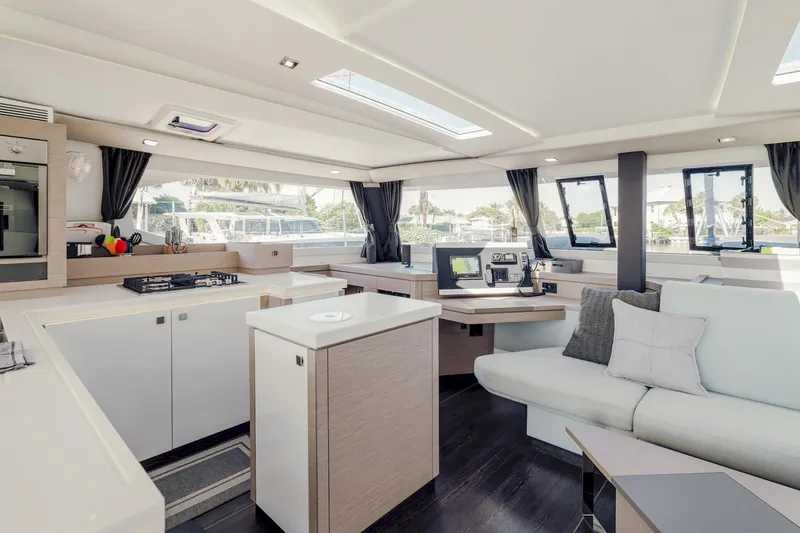 Slide: The Image of Luxurious interior of 2020 Fountaine Pajot Saona 47 catamaran with modern kitchen and seating area. - 4
